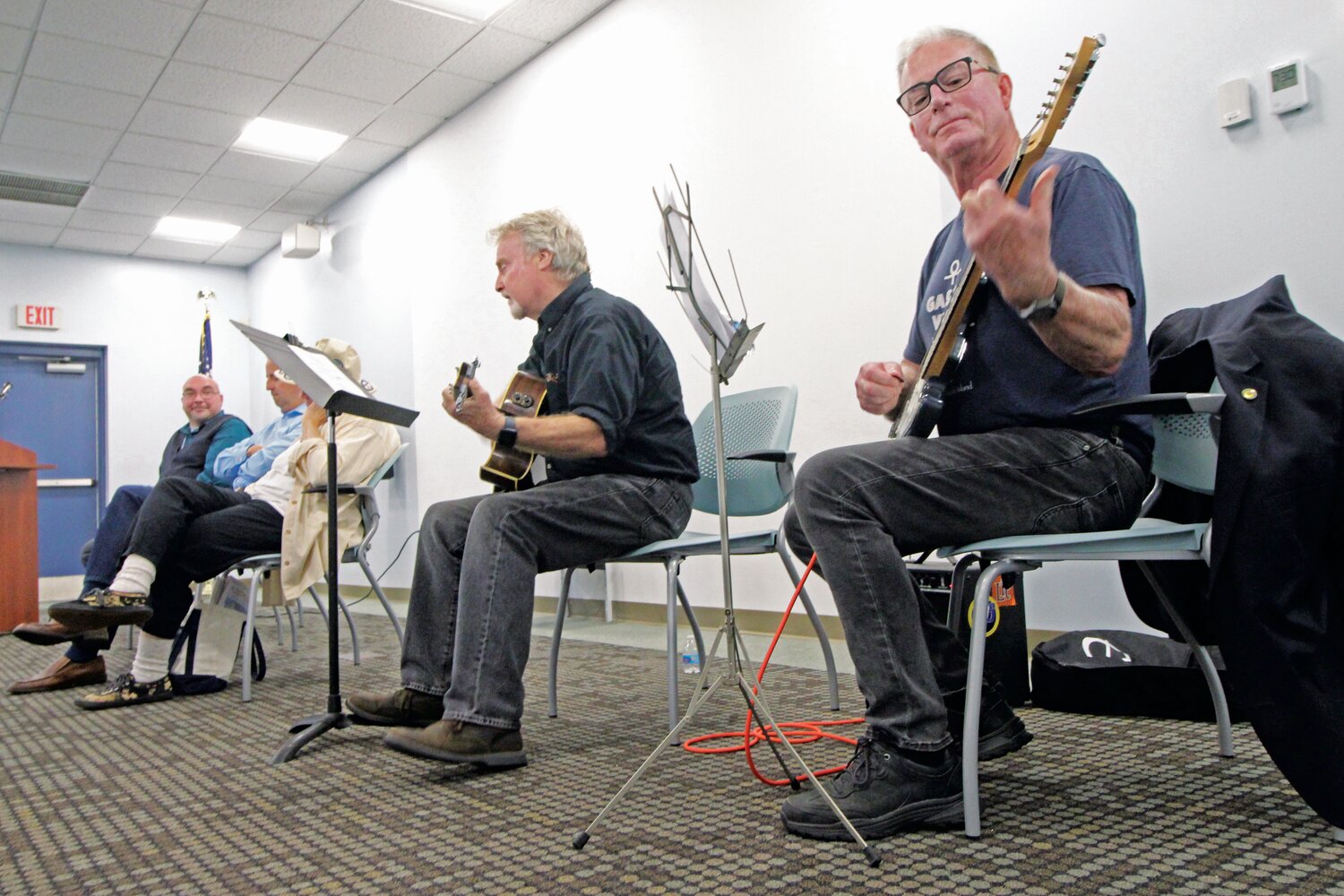 ROCKING THE GASPEE: John Foley and Rep. Joe McNamara on guitar teamed up to play McNamara’s composition during the opening of the Gaspee display at the Warwick Library on Saturday. (Warwick Beacon photos)